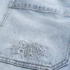 Broderte, lysevaskede skaterbaggyjeans