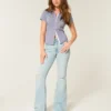Høy midje, revne, lysevaskede flare-jeans