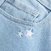 Lavt sittende bootcut-jeans med stjernebroderi