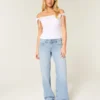 Lavt sittende, lysvasket baggy jeans med nitter og sløyfer