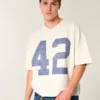 Tung baggy kort fotball-T-skjorte med grafikk