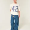Tung baggy kort fotball-T-skjorte med grafikk