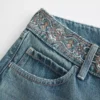 Ultra lav midje, medium vask, brodert baggy jeans