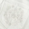 Ultra lavt sittende hvite broderte lommerskinnebukser