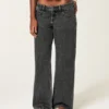 Ultra lavt sittende, vasket svart baggy jeans med spenne bak