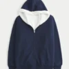 Vendbar fleece-hoodie med glidelås og fuskepelsfôr